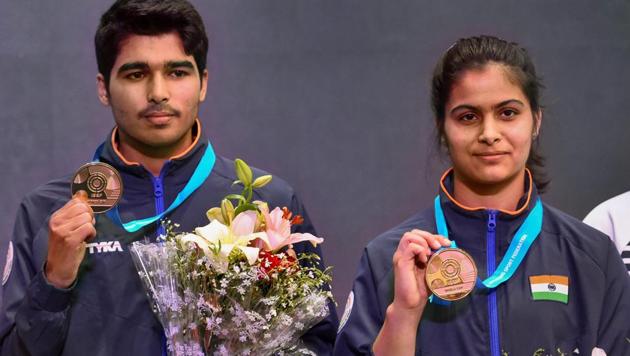 India's Manu Bhaker (R) and Saurabh Chaudhary pose for photographs with their gold medals after winning the 10m Air Pistol Mixed Team event at the ISSF World Cup(PTI)