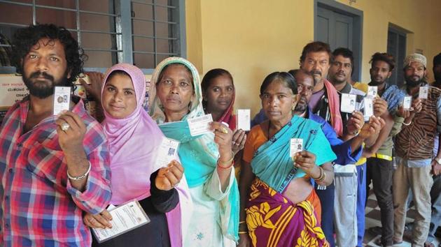 Voters show their ID cards as they wait in a queue to cast vote at a polling station, during the 2nd phase of Lok Sabha elections.(PTI file photo)
