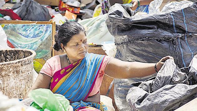 A sanitation worker works without gloves at a garbage dump yard in Balewadi, Pune, on Friday, April 19. (Milind Saurkar/HT Photo) A sanitation worker works without gloves at a garbage dump yard in Balewadi, Pune, on Friday, April 19. (Milind Saurkar/HT Photo)