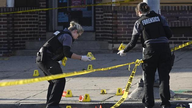 Baltimore police forensics officers place evidence markers next to bullet casings while investigating the scene of a shooting in Baltimore on Sunday, April 28, 2019.(AP) Baltimore police forensics officers place evidence markers next to bullet casings while investigating the scene of a shooting in Baltimore on Sunday, April 28, 2019.(AP)