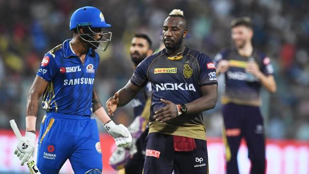 Kolkata Knight Riders' cricketer Andre Russell (C) congratulates Mumbai Indians' cricketer Hardik Pandya (L) for his innings after Pandya lost his wicket during the 2019 Indian Premier League (IPL)(AFP)