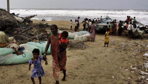 A woman evacuates the coast with her children in Ganjam district, Odisha following a cyclone alert. (AP file photo) A woman evacuates the coast with her children in Ganjam district, Odisha following a cyclone alert. (AP file photo)
