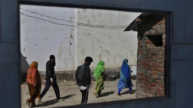 Kashmiri voters arriving to vote are reflected on a mirror outside a polling station at Bumthan, south of Srinagar. Unlike the previous phase, when Jammu and Kashmir’s Anantnag recorded 0% polling in the first two hours, on Monday voters turned up early at several booths. Monday is the second round of voting in Anantnag, which is scheduled go to polls in three phases. (Mukhtar Khan / AP) Kashmiri voters arriving to vote are reflected on a mirror outside a polling station at Bumthan, south of Srinagar. Unlike the previous phase, when Jammu and Kashmir’s Anantnag recorded 0% polling in the first two hours, on Monday voters turned up early at several booths. Monday is the second round of voting in Anantnag, which is scheduled go to polls in three phases. (Mukhtar Khan / AP)