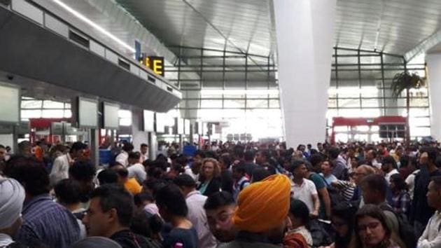 Passengers wait at Indira Gandhi International Airport due to delays in Air India flights in New Delhi on Saturday. (ANI)