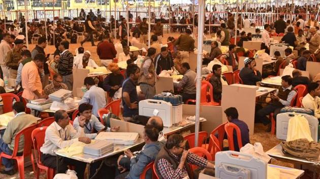 Election officers check polling materials ahead of polling.(Mujeeb Faruqui/HT Photo)