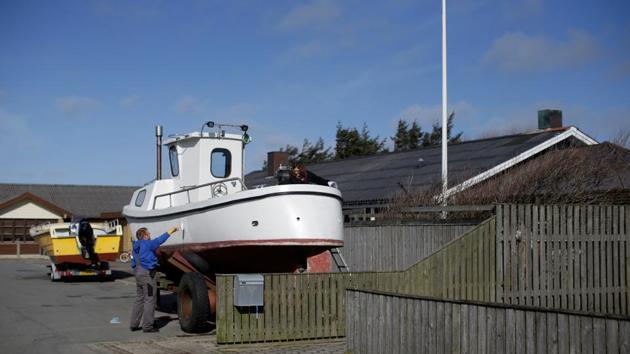 Fisherman Michael Bork paints his boat outside his house with his partner Sabrina Mikkelsen during his time on land. “This town could end up closing down because of Brexit,” said Bork, 36, who has been fishing since the age of 10. Between 30 and 40% of the catch landed in Thyboron Port come from British waters. (Andrew Kelly / REUTERS) Fisherman Michael Bork paints his boat outside his house with his partner Sabrina Mikkelsen during his time on land. “This town could end up closing down because of Brexit,” said Bork, 36, who has been fishing since the age of 10. Between 30 and 40% of the catch landed in Thyboron Port come from British waters. (Andrew Kelly / REUTERS)