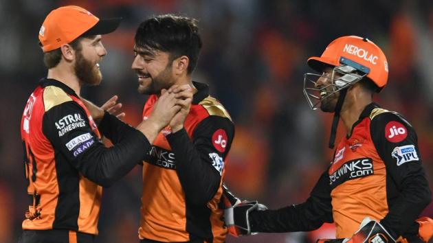 Sunrisers Hyderabad cricketer Rashid Khan (C) celebrates with his captain Kane Williamson (L).(AFP)