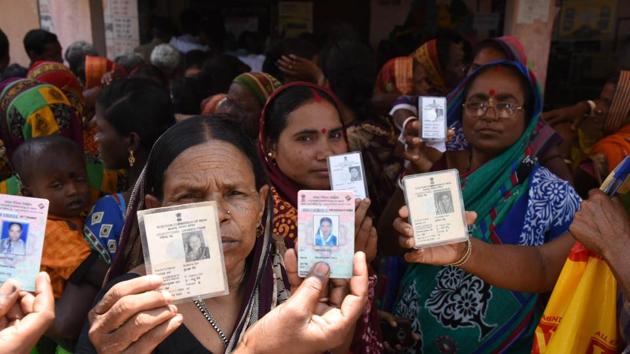 Odisha, India-April 29, 2019: Voters show their voter's identity cards as they wait to cast their votes during the 4th phase of Lok Sabha elections at a polling station , in Kendrapara district, Odisha, India, on Monday, April 29, 2019. (Photo by Arabinda Mahapatra / Hindustan Times)(Arabinda Mohapatra)