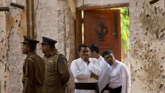 Clergymen visit the scene after the suicide bombing at St. Sebastian’s Church. It’s still not clear exactly how many died on Sunday at the Negombo church, but perhaps nearly half of the roughly 250 people killed in the Easter bombings that targeted churches and high-end hotels. (Gemunu Amarasinghe / AP) Clergymen visit the scene after the suicide bombing at St. Sebastian’s Church. It’s still not clear exactly how many died on Sunday at the Negombo church, but perhaps nearly half of the roughly 250 people killed in the Easter bombings that targeted churches and high-end hotels. (Gemunu Amarasinghe / AP)