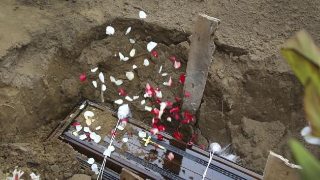 Relatives throw flower petals on the coffin of Dhami Brandy, 13, a victim of Easter Sunday's bomb blast at St. Sebastian Church, in Negombo. For more than 50 years, St. Sebastian’s had been the scene of weddings and baptisms, of Christmas celebrations and countless Masses. (Manish Swarup / AP) Relatives throw flower petals on the coffin of Dhami Brandy, 13, a victim of Easter Sunday's bomb blast at St. Sebastian Church, in Negombo. For more than 50 years, St. Sebastian’s had been the scene of weddings and baptisms, of Christmas celebrations and countless Masses. (Manish Swarup / AP)