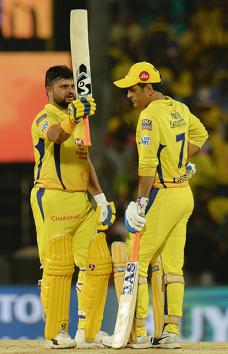 Chennai Super Kings cricketer Suresh Raina (L) raises his bat to celebrate his half century (50 runs) next to teammate Mahendra Singh Dhoni during the 2019 Indian Premier League (IPL) Twenty20 cricket match between Chennai Super Kings and Delhi Capitals at the M.A. Chidambaram Stadium in Chennai. (AFP)