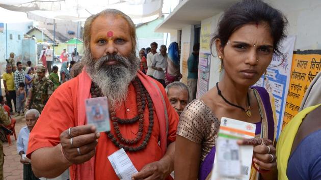 Voters queue up to cast their vote at a polling station in Madhya Pradesh.(ANI Photo)