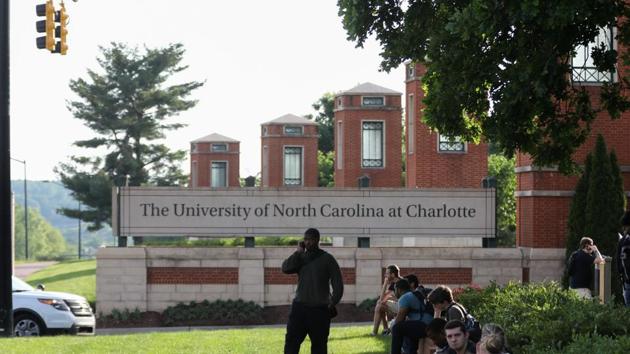 Students and faculty wait near the entrance of campus after a shooting on the campus of University of North Carolina Charlotte in University City, Charlotte, on April 30, 2019.(AFP) Students and faculty wait near the entrance of campus after a shooting on the campus of University of North Carolina Charlotte in University City, Charlotte, on April 30, 2019.(AFP)