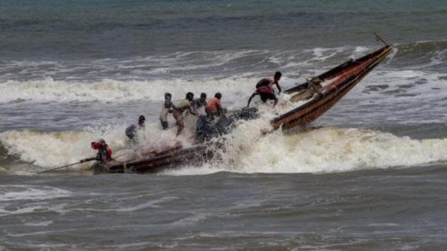 Fishermen try to control their boat amidst rough sea waters at Puri beach, Tuesday, April 30 2019. (PTI Photo) Fishermen try to control their boat amidst rough sea waters at Puri beach, Tuesday, April 30 2019. (PTI Photo)