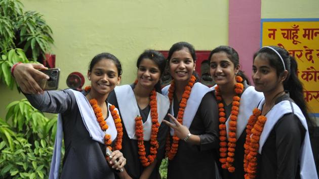 Students of Rani Laxmibai Memorial Senior Secondary School celebrating their success after declaration of CBSE Class 12 results in Lucknow. Out of 23 students who figured in the CBSE merit list, 13 are from Uttar Pradesh.(Deepak Gupta/HT photo)