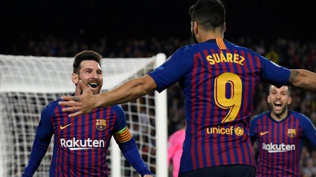 Barcelona's Argentinian forward Lionel Messi celebrates with Barcelona's Uruguayan forward Luis Suarez (R) after scoring a goal during the UEFA Champions League semi-final first leg football match between Barcelona and Liverpool(AFP)