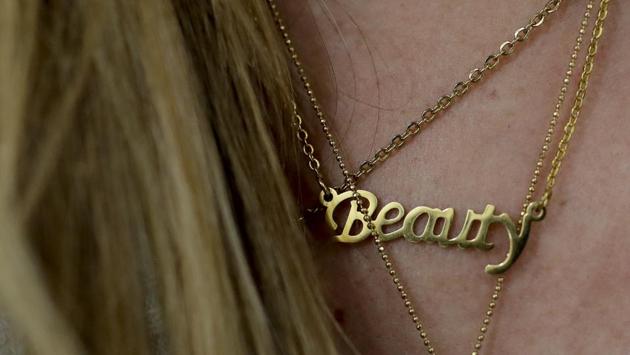 Carolina Dejan wears a necklace featuring the word “Beauty” at a beauty salon where she is getting extensions using real hair from women who sold theirs. Many have to adapt to make personal care products last longer, with no sign of an end to a crisis that has pushed more than 3 million Venezuelans — one-tenth of the population — to leave the country in recent years. (Natacha Pisarenko / AP) Carolina Dejan wears a necklace featuring the word “Beauty” at a beauty salon where she is getting extensions using real hair from women who sold theirs. Many have to adapt to make personal care products last longer, with no sign of an end to a crisis that has pushed more than 3 million Venezuelans — one-tenth of the population — to leave the country in recent years. (Natacha Pisarenko / AP)