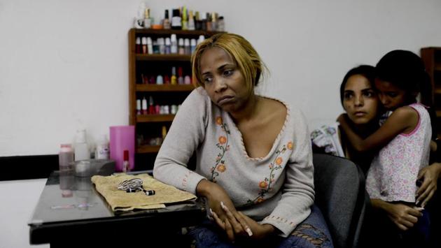 Manicurist Maria Trinidad Tobar waits for customers at a beauty salon in Caracas. Tobar said Venezuelan women no longer prioritize getting made up, but instead focus on buying food in a country where the IMF predicts hyperinflation will reach 10,000,000% this year. (Natacha Pisarenko / AP) Manicurist Maria Trinidad Tobar waits for customers at a beauty salon in Caracas. Tobar said Venezuelan women no longer prioritize getting made up, but instead focus on buying food in a country where the IMF predicts hyperinflation will reach 10,000,000% this year. (Natacha Pisarenko / AP)