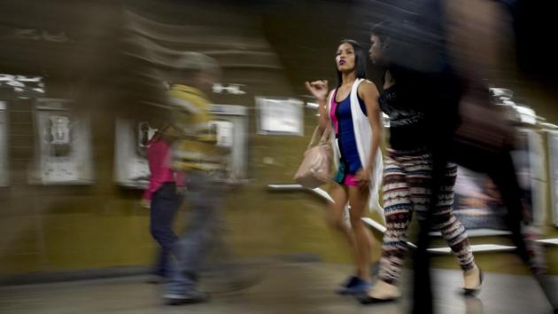A woman wearing makeup and with her hair straightened walks through the subway in Caracas. Local shops that sell beauty products are also reinventing themselves to stay afloat. International cosmetics brands have disappeared from storefronts, replaced by cheaper goods from China as well as locally made products that use honey and other ingredients. (Natacha Pisarenko / AP) A woman wearing makeup and with her hair straightened walks through the subway in Caracas. Local shops that sell beauty products are also reinventing themselves to stay afloat. International cosmetics brands have disappeared from storefronts, replaced by cheaper goods from China as well as locally made products that use honey and other ingredients. (Natacha Pisarenko / AP)