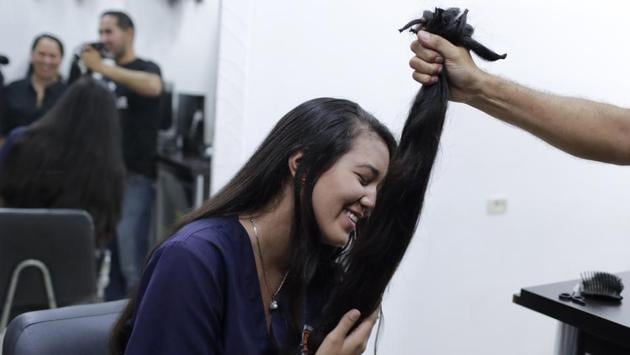 Valery Diaz holds the hair she had cut off. Despite sacrificing her hair, Diaz said she still tries to buy cosmetics, using money she earns from making and selling bracelets. Diaz said she still dreams of becoming a Miss Venezuela someday, when “my hair grows again.” (Natacha Pisarenko / AP) Valery Diaz holds the hair she had cut off. Despite sacrificing her hair, Diaz said she still tries to buy cosmetics, using money she earns from making and selling bracelets. Diaz said she still dreams of becoming a Miss Venezuela someday, when “my hair grows again.” (Natacha Pisarenko / AP)