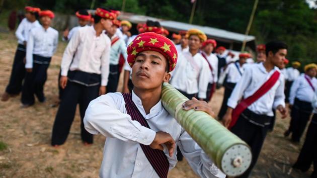 Others, like Nan Pyone Kha Cho, 21, chose a more modern approach, sporting turbans of scarlet, gold or silver. A golden hairpin is the “mother dragon’s fang”, she explained. Men wear rolled-up cloth of various hues on their heads in the image of the “weiza” as they parade singing and dancing into the village, holding aloft their homemade rockets. (Ye Aung Thu / AFP)