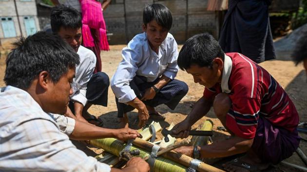 In the past, these rockets were crafted entirely from bamboo and would carry up to 40 kilos of explosives. Now they are made with bamboo-wrapped metal, holding five different grades of gunpowder. (Ye Aung Thu / AFP)