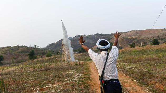 A Pa'O ethnic man dances while watching the launch of a homemade rocket. They can land up to seven or eight kilometres away, creating craters 1.5 metres deep in the fields. A team of “linesmen” note the landing positions so they can later be collected. (Ye Aung Thu / AFP)