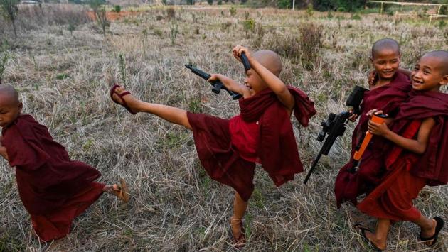 Buddhist novices play with toy guns during the rocket festival in Nantar. As the sun set and the rockets fell silent, the next generation in training took over. Groups of boys set off fireworks to squeals of delight and fired toy guns into the air in celebration. (Ye Aung Thu / AFP)
