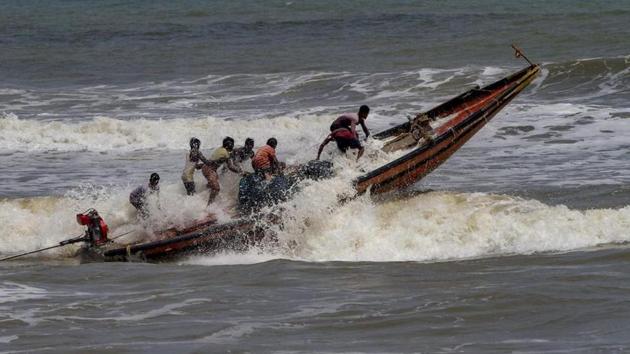 Fishermen try to control their boat amidst rough sea waters at Odisha’s Puri beach, Tuesday, April 30 2019.(PTI Photo)