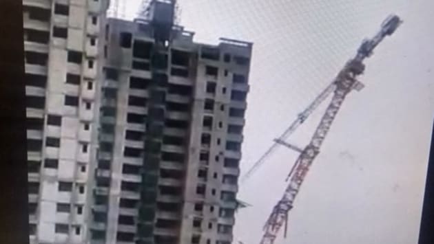 In one video, a crane can be seen standing beside an under-construction building. In one video, a crane can be seen standing beside an under-construction building.