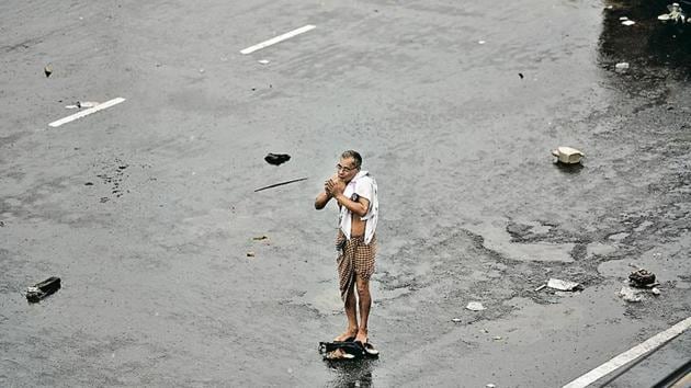 A man folds his hands in prayer as cyclone Fani hits the coast, in Puri, Odisha, on Friday.(Arijit Sen/HT Photo)