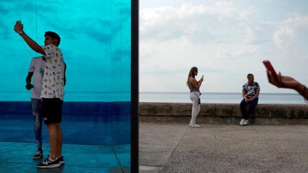 People take pictures next to a creation of Cuban artist Rachel Valdez during the 13th Havana Biennial, in Havana, Cuba. (Alexandre Meneghini / REUTERS)