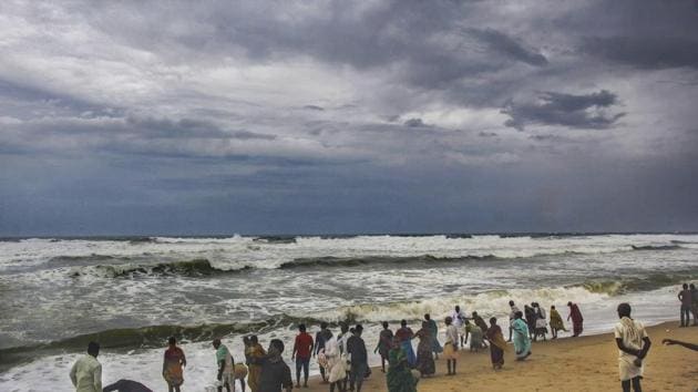 Puri: Villagers at the beach as dark clouds hover above the sea ahead of cyclone 'Fani', in Puri, Thursday, May 2, 2019.(PTI)