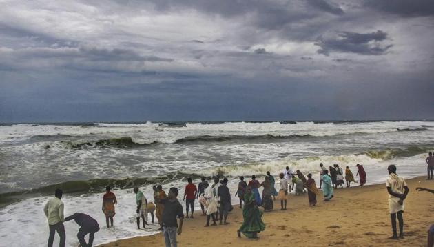 Puri: Villagers at the beach as dark clouds hover above the sea ahead of cyclone 'Fani', in Puri. (PTI) Puri: Villagers at the beach as dark clouds hover above the sea ahead of cyclone 'Fani', in Puri. (PTI)
