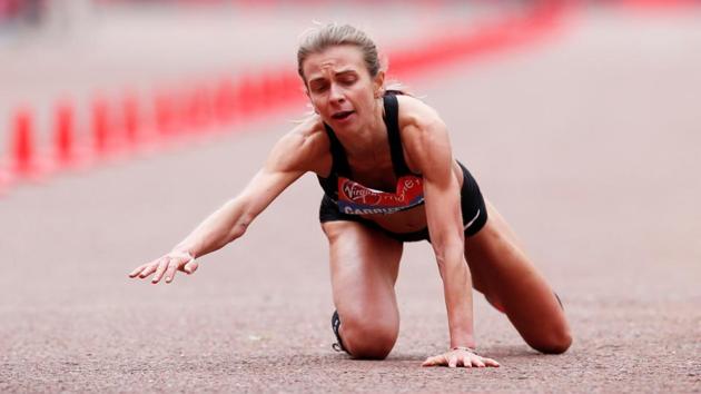 Great Britain’s Hayley Carruthers falls from exhaustion at the end of the women’s elite race during the 2019 London Marathon in London England. (Paul Childs / REUTERS)