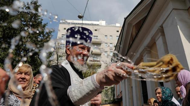 A priest blesses cakes and eggs on the eve of the Orthodox Easter in Moscow, Russia. (Evgenia Novozhenina / REUTERS)