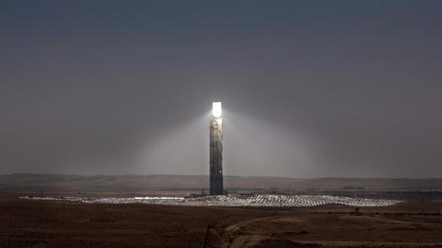Sunlight is reflecting on the mirrors placed on the top of the Ashalim solar tower near the southern Israeli kibbutz of Ashalim in the Negev desert. In the middle of the desert, a field of mirrors expanding 300 hectares will stretch out, directing sunlight toward the tower’s peak to an area called the boiler where electricity is produced. (Thomas Coex / AFP)