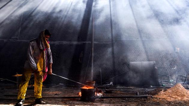 A Pakistani labourer works at an iron factory on the eve of the International Labour Day or May Day, in Lahore, Pakistan. (Arif Ali / AFP)