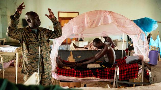 A South Sudan People’s Defence Force chaplain prays during a visit to soldiers at Juba Military Hospital in Juba, South Sudan. (Alex McBride / AFP)