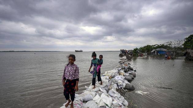 Bangladeshi children walk on top of a sandbag embankment that was breached by high waters in Khulna as cyclone Fani reached Bangladesh. At least 12 have been killed across Bangladesh due to the cyclonic storm Fani, which is expected to stay over the country until 4 pm today, according to a news report. (Munir Uz Zaman/ AFP) Bangladeshi children walk on top of a sandbag embankment that was breached by high waters in Khulna as cyclone Fani reached Bangladesh. At least 12 have been killed across Bangladesh due to the cyclonic storm Fani, which is expected to stay over the country until 4 pm today, according to a news report. (Munir Uz Zaman/ AFP)