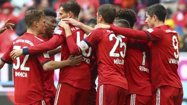 Bayern's players celebrate after scoring their side's third goal.(AP)