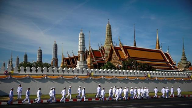 Officials walk past the Grand Palace during the coronation of King Maha Vajiralongkorn in Bangkok. (Navesh Chitrakar / REUTERS) Officials walk past the Grand Palace during the coronation of King Maha Vajiralongkorn in Bangkok. (Navesh Chitrakar / REUTERS)