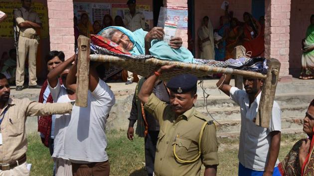 Security personnel carry an elderly woman to a polling station to cast vote at Hajipur in Vaishali district. The BJP’s share in seats contested by the NDA in 2014 was also highest in the seats that poll today. It fought all seats, except Hajipur and Sitamarhi in Bihar, going to polls and won 39 of them. The BJP is contesting the same 49 PCs in 2019 which it had contested in 2014. (PTI) Security personnel carry an elderly woman to a polling station to cast vote at Hajipur in Vaishali district. The BJP’s share in seats contested by the NDA in 2014 was also highest in the seats that poll today. It fought all seats, except Hajipur and Sitamarhi in Bihar, going to polls and won 39 of them. The BJP is contesting the same 49 PCs in 2019 which it had contested in 2014. (PTI)