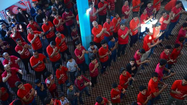 Teens in matching red shirts stand shoulder to shoulder in their local place of worship as if preparing for prayer and the ear-splitting drums reverberate around the hall as Iraqi teenagers shout rhymes venerating the Prophet Mohammad’s grandson and other honoured figures in Islam. (Haidar Hamdani / AFP) Teens in matching red shirts stand shoulder to shoulder in their local place of worship as if preparing for prayer and the ear-splitting drums reverberate around the hall as Iraqi teenagers shout rhymes venerating the Prophet Mohammad’s grandson and other honoured figures in Islam. (Haidar Hamdani / AFP)