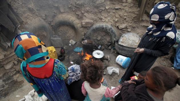 Women cook a meal after they received food aid from the local charity, Mona Relief, ahead of the holy month of Ramzan in a slum on the outskirts of Sanaa, Yemen. (Khaled Abdullah / REUTERS) 