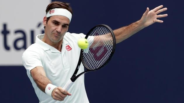 Roger Federer, of Switzerland returns to John Isner, during the singles final of the Miami Open.(AP)