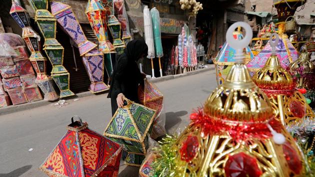 A woman buys traditional lanterns called “fanous”, made of thick fabric called “khayamiya”, at a stall ahead of the Muslim holy month of Ramzan in Cairo. The intense nights of prayer will eventually be met with the three-day holiday of Eid al-Fitr. (Amr Abdallah / REUTERS) 
