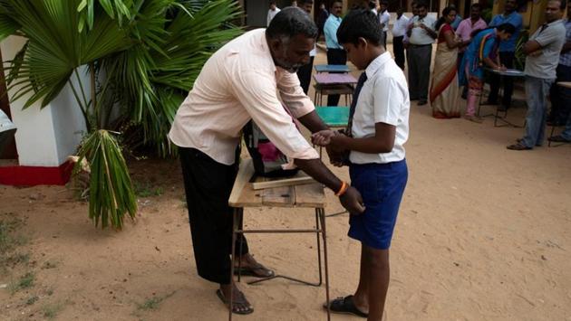 A student is frisked by a parent as he arrives at his school in Batticaloa. Despite the tight security and military patrols, most classrooms were near empty on Monday. Private schools, including Catholic institutions, remained closed. (Danish Siddiqui / REUTERS) A student is frisked by a parent as he arrives at his school in Batticaloa. Despite the tight security and military patrols, most classrooms were near empty on Monday. Private schools, including Catholic institutions, remained closed. (Danish Siddiqui / REUTERS)