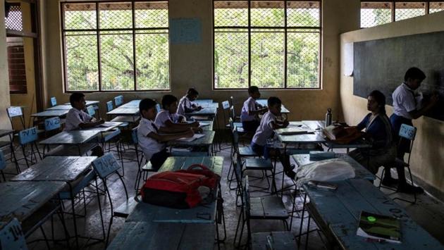 At a Hindu school in Batticaloa on the east coast, site of one of the church bombings, parents helped to search schoolbags at the entrance gate. Once inside, pupils sat in desks away from road-side windows. “Parents are not confident that safety has returned to normal,” said T. Yasodharan, principal of Sivananda College where only 30% of its students showed up on Monday. (Danish Siddiqui / REUTERS) At a Hindu school in Batticaloa on the east coast, site of one of the church bombings, parents helped to search schoolbags at the entrance gate. Once inside, pupils sat in desks away from road-side windows. “Parents are not confident that safety has returned to normal,” said T. Yasodharan, principal of Sivananda College where only 30% of its students showed up on Monday. (Danish Siddiqui / REUTERS)