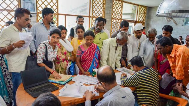 People check their names in the National Register of Citizens (NRC) list during a hearing at a Seva Kendra, in Guwahati, Tuesday, May 07, 2019. (PTI) People check their names in the National Register of Citizens (NRC) list during a hearing at a Seva Kendra, in Guwahati, Tuesday, May 07, 2019. (PTI)